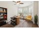 Home office featuring bay windows, desk, ceiling fan, wood-style floors, and natural light at 453 Kays Landing Dr, Sanford, FL 32771