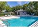 Community pool featuring comfortable lounge chairs, an umbrella, and a pool house at 453 Kays Landing Dr, Sanford, FL 32771