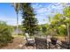 Scenic backyard featuring a seating area with lake views, mature trees, and a serene ambiance at 4561 Heritage Oak Dr, Orlando, FL 32808