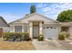 Charming single-story home featuring a well-maintained lawn, inviting entrance, and attached garage at 4561 Heritage Oak Dr, Orlando, FL 32808