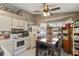 View of the eat-in kitchen showcasing white appliances, lots of storage, and an open floor plan at 4561 Heritage Oak Dr, Orlando, FL 32808