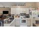 Well-lit kitchen with white appliances and an abundance of cabinet and counter space at 4561 Heritage Oak Dr, Orlando, FL 32808