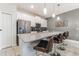 Modern kitchen featuring stainless steel appliances, a spacious island, and pendant lighting at 4983 Windermere Ave, Kissimmee, FL 34746