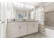 Bright, modern bathroom featuring double sinks and a combination shower and bath at 4983 Windermere Ave, Kissimmee, FL 34746