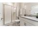 Bright bathroom features a modern vanity, tiled floor, and glass shower at 4983 Windermere Ave, Kissimmee, FL 34746