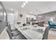 Bright dining area with a large table and modern chandelier next to the kitchen at 4983 Windermere Ave, Kissimmee, FL 34746
