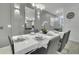 Dining room with a large mirror and stylish decorations and modern table setting at 4983 Windermere Ave, Kissimmee, FL 34746