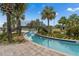 Community lazy river featuring tropical landscaping and a wooden bridge at 4983 Windermere Ave, Kissimmee, FL 34746