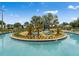 Community lazy river with a small island of trees and landscaping in the center at 4983 Windermere Ave, Kissimmee, FL 34746