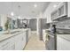 Bright kitchen featuring stainless steel appliances, granite countertops, and ample cabinet space at 4983 Windermere Ave, Kissimmee, FL 34746