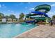 Community water slide with palm trees and lush landscaping around the splash pool at 4983 Windermere Ave, Kissimmee, FL 34746