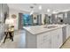 Bright kitchen with white cabinetry, stainless steel appliances, and a large island with seating at 4983 Windermere Ave, Kissimmee, FL 34746