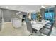Open-concept dining area with modern furnishings, seamlessly connected to the kitchen and living spaces at 4983 Windermere Ave, Kissimmee, FL 34746