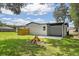 Expansive backyard featuring a patio, fire pit, and lush green lawn perfect for outdoor entertaining at 50 Community Dr, Debary, FL 32713