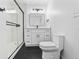 Modern bathroom with glass shower, black fixtures, and white vanity with sleek mirror at 50 Community Dr, Debary, FL 32713