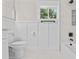 Bright white bathroom featuring modern fixtures, tub/shower combo, and marble-look tile at 50 Community Dr, Debary, FL 32713