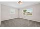 Cozy carpeted bedroom with natural light streaming through two windows at 50 Community Dr, Debary, FL 32713