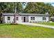 A neat front yard enhances this home's appeal, offering a glimpse of its inviting atmosphere and cozy charm at 50 Community Dr, Debary, FL 32713