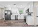 The bright kitchen boasts stainless steel appliances, white cabinets, and hardwood floors, a perfect blend of style and function at 50 Community Dr, Debary, FL 32713
