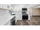 Kitchen featuring a sleek stainless steel dishwasher and a contrasting black faucet at 50 Community Dr, Debary, FL 32713