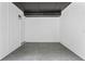 Enclosed room with gray tiled floors, white paneled walls, and dark ceiling at 50 Community Dr, Debary, FL 32713