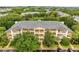 Aerial view showcasing the well-maintained complex, lush trees, and manicured landscaping at 510 Rum Run # 33 510, Davenport, FL 33837