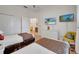 A bedroom featuring two twin beds, wicker drawers, two wall-mounted TVs, and a cheerful design at 510 Rum Run # 33 510, Davenport, FL 33837