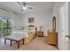 Bedroom with a queen bed, wicker furniture, and an outdoor balcony perfect for relaxation at 510 Rum Run # 33 510, Davenport, FL 33837