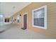Exterior view features a covered entryway, multiple windows, and a brown front door with welcome mat at 510 Rum Run # 33 510, Davenport, FL 33837