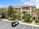 Beautiful condo building featuring multiple stories, balconies, lush landscaping, and convenient parking at 510 Rum Run # 33 510, Davenport, FL 33837