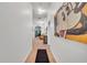 Bright hallway with neutral tones and whimsical art accents lead to the main living area at 510 Rum Run # 33 510, Davenport, FL 33837