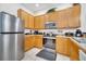 Well-equipped kitchen featuring stainless steel appliances and oak cabinetry at 510 Rum Run # 33 510, Davenport, FL 33837