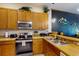 Well-equipped kitchen with stainless steel appliances and dark backsplash at 510 Rum Run # 33 510, Davenport, FL 33837
