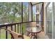 A cozy patio with table and chairs overlooking a grassy area at 510 Rum Run # 33 510, Davenport, FL 33837