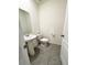 Half bathroom with modern pedestal sink and tiled floors at 5168 Greenheart Ave, Mount Dora, FL 32757