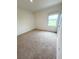 Bedroom featuring carpeted floors, neutral paint, and bright natural light at 5168 Greenheart Ave, Mount Dora, FL 32757