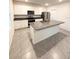 Modern kitchen featuring white cabinets, stainless steel appliances, and granite countertops at 5168 Greenheart Ave, Mount Dora, FL 32757