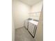 Laundry room featuring a washer and dryer hookup with tiled floors and wire shelving at 5168 Greenheart Ave, Mount Dora, FL 32757