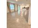 Bright and spacious living room with tiled floors, flowing seamlessly into the kitchen at 5168 Greenheart Ave, Mount Dora, FL 32757