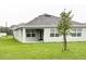Extended backyard featuring a newly planted sapling tree with spacious green area at 5216 Greenheart Ave, Mount Dora, FL 32757