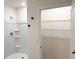 All white bathroom featuring a walk-in shower stall and a large storage closet at 5216 Greenheart Ave, Mount Dora, FL 32757