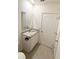 Cozy bathroom with a granite vanity top and a framed mirror at 5216 Greenheart Ave, Mount Dora, FL 32757