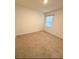 Neutral bedroom with carpet flooring, window, and white walls providing an airy feel at 5216 Greenheart Ave, Mount Dora, FL 32757