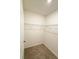 A carpeted walk-in closet with a wire shelving unit for optimal storage and organization at 5216 Greenheart Ave, Mount Dora, FL 32757