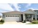 Charming single-story home featuring a two-car garage, neutral paint, and well-maintained landscaping at 5216 Greenheart Ave, Mount Dora, FL 32757