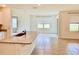 Open kitchen concept shows tiled floors, granite counters and adjacent living space with large windows at 5216 Greenheart Ave, Mount Dora, FL 32757