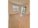 Bright living room area with tiled floors, large windows and a sliding glass door to the outside at 5216 Greenheart Ave, Mount Dora, FL 32757
