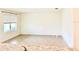 Open concept living space with large windows, tiled floors and bright neutral paint at 5216 Greenheart Ave, Mount Dora, FL 32757