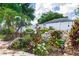 Beautiful landscaped backyard with colorful flowers, rock features, and a privacy fence offers a serene outdoor space at 603 Yorkshire Dr, Oviedo, FL 32765