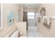This bathroom features neutral walls, tile flooring, a shower, and decorative wall art at 603 Yorkshire Dr, Oviedo, FL 32765